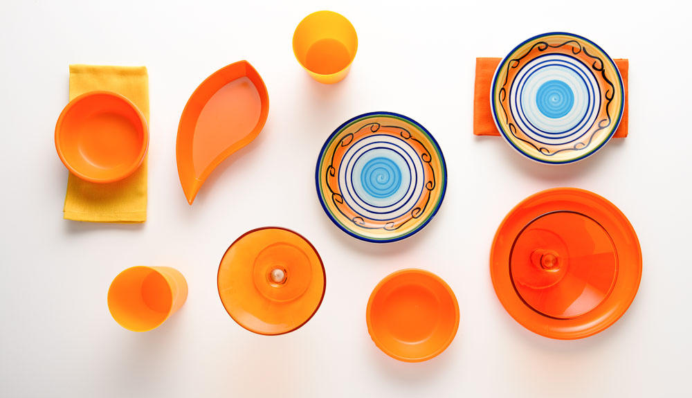 Arrangement of Orange Plates, Bowls, Cups and Glasses