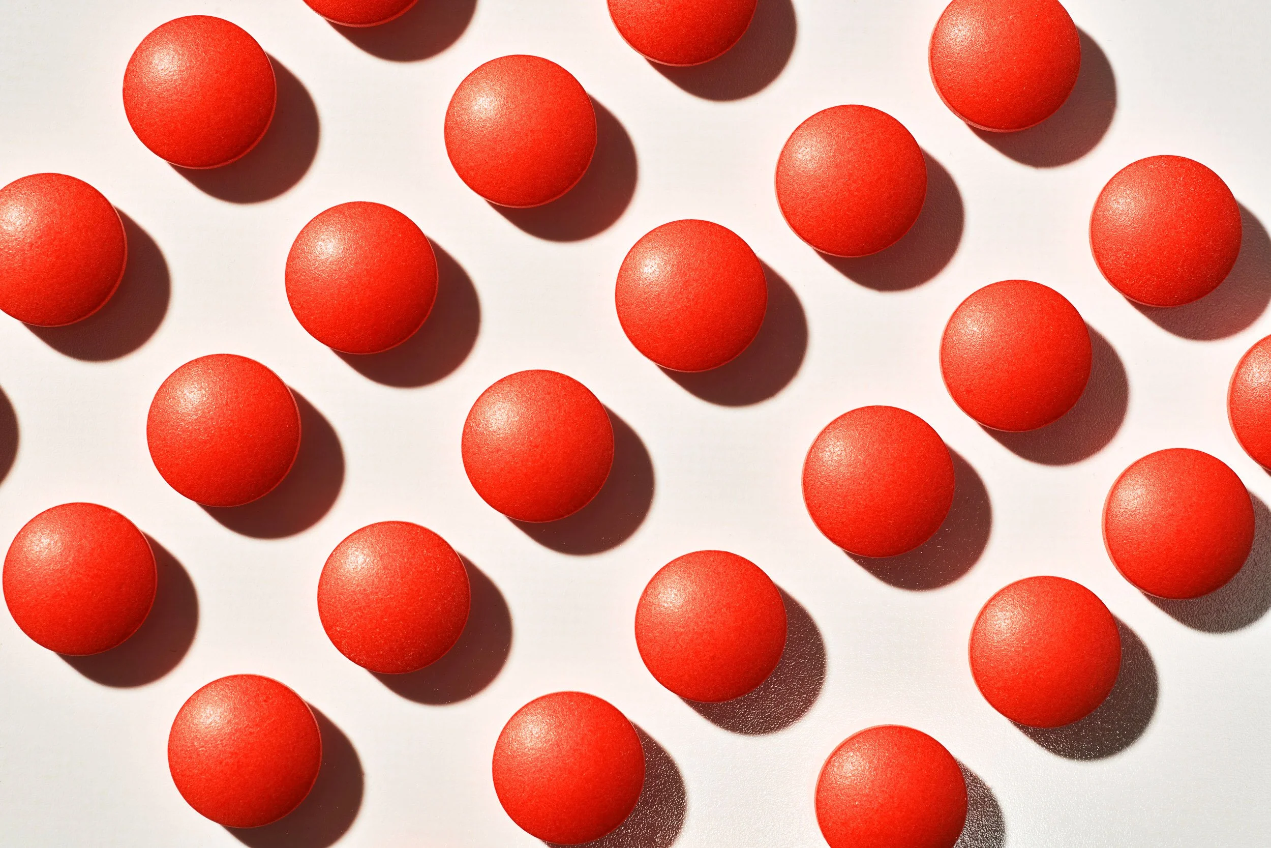 Red Pills on White in Still Life Studio 