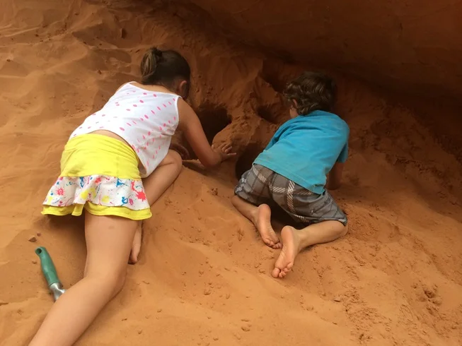 Tag and Elle building arches in the sand at Sand Arch.