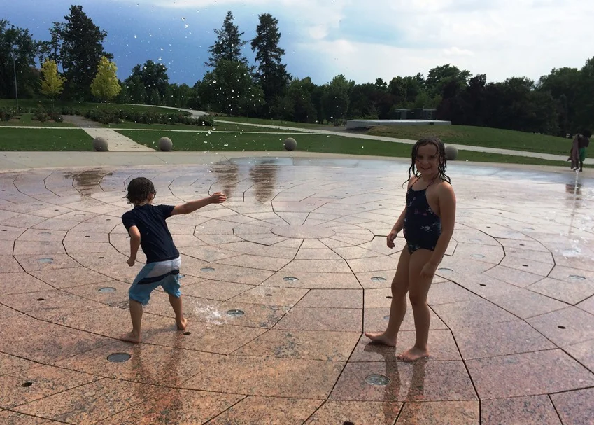 Tag went to battle with the shooting water while Elle slyly positioned herself over the spray nozzles causing water to shoot out at Tag from under her foot
