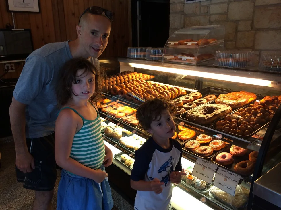 Yes, that is a donut in the case beside Tag's head. No, we did not get one, but Tag tried.