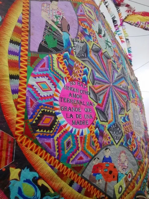 From the front, it's nearly impossible to see any tape. I suspect there is glue too, but it's done to blend in with the design on the kite. The detail reminds me of complex patterns sewed into intricately made quilts. 