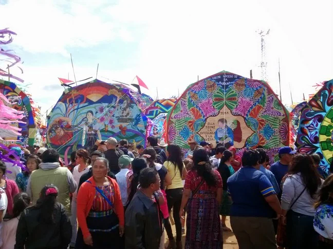 Sumpango, the second celebration we attended. The cemetery is off to the side and the kites are erected in an open, muddy field. We all went home with dirty shoes. Tag's, of course, were the dirtiest!