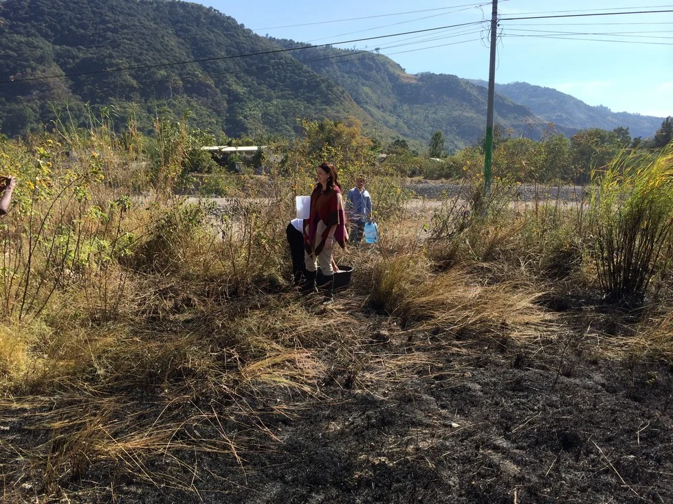The LIFE School Director, the Guardian and a teacher pouring water on the fire. Notice the teacher in the background holding a 5 gallon water container that he used. The director (in front) is holding a white pitcher that she filled using water from…