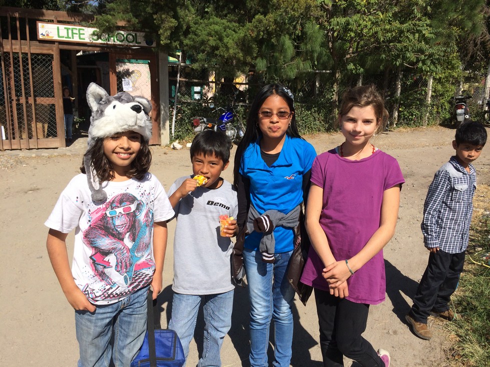 After the fire - Santiago, Brandon, Xeila, and Tara, some of our volunteer student firefighters,&nbsp;relaxing after their hard work filling containers with water. Brandon&nbsp;is eating a common snack -&nbsp;corn on the cob smothered in mayonnaise …