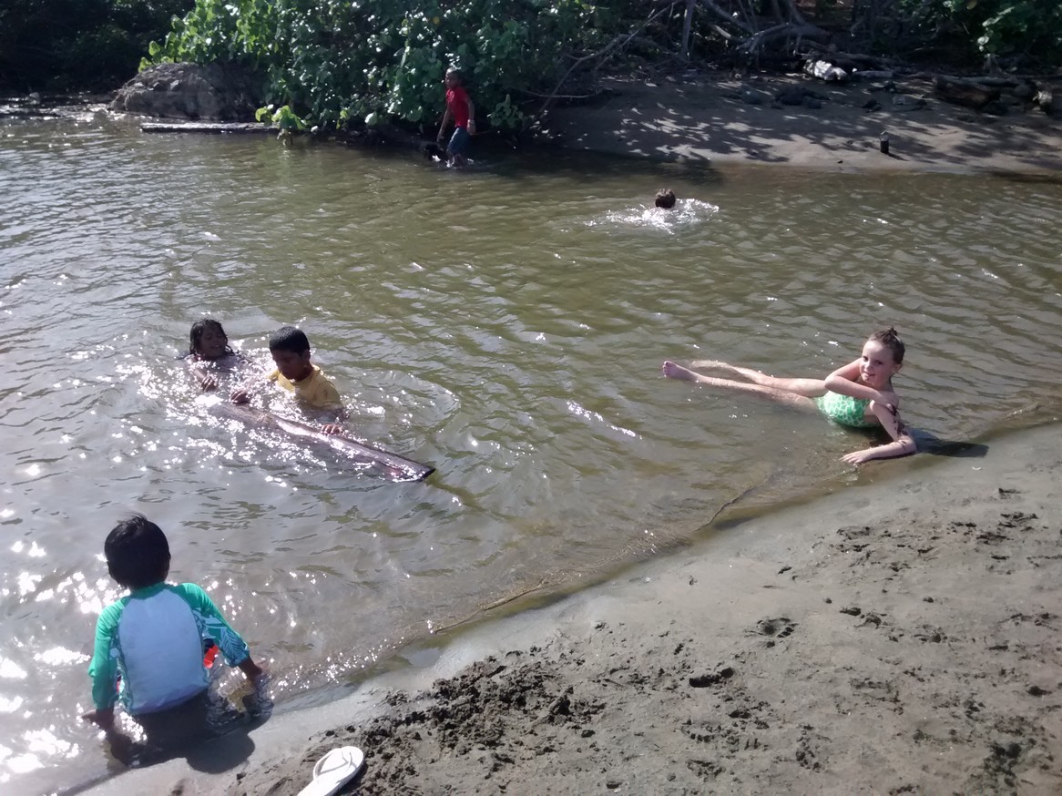 While Mick and I were at the coast line, the kids were farther inland playing with locals in a big, safe tidal pool. The local kids were using driftwood to act as boats in the water. 