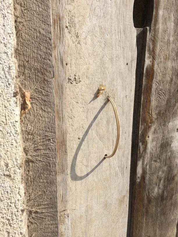 A little bit of white speaker cable will double nicely as a door handle.