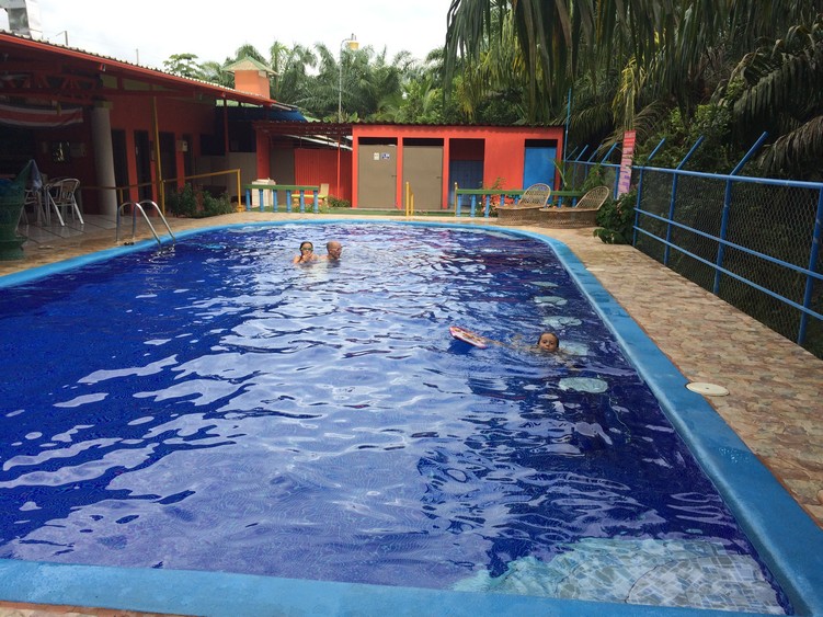 The far, circular end of the pool is only 2 feet deep which is perfect when the kids need a little rest, but don't want to get out of the water. The shower, bathroom and dressing room are in the background. Tag (on the right) likes swimming from stool to stool. 