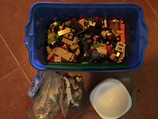 We're down to one bin that isn't full to the rim. We have room for some bowls (that we used for sorting the Legos), a baggie of characters for each kid and one set with directions for each kid too. Everyone is happy.