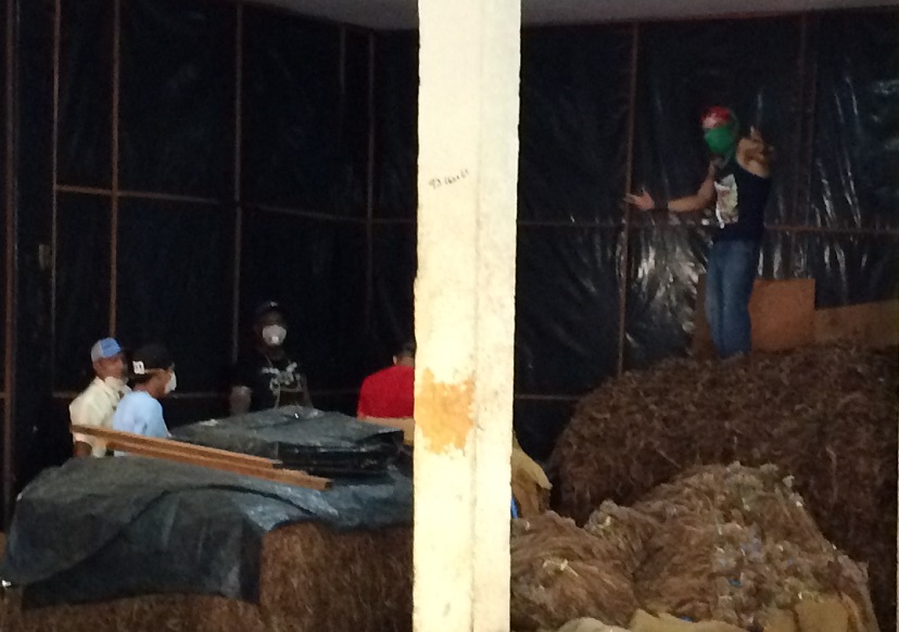 Note the masks on the face of the workers. It's essentially a bandana. This is a man's job in the factory.