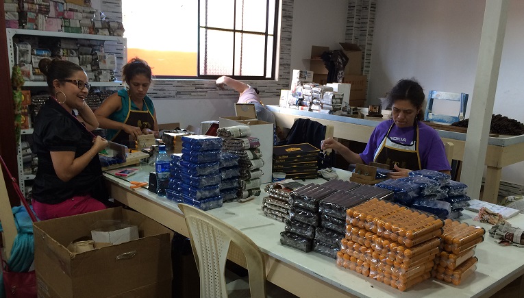 This team of women is paid according to the number of cigars they package. 