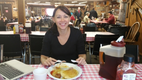 Siobhan enjoying some fine local cuisine, including maple syrup sucked directly from the trees outside at mclachlan family maple syrup farm in komoka ontario. the jug of syrup would unfortunately not fit in her carry on luggage.