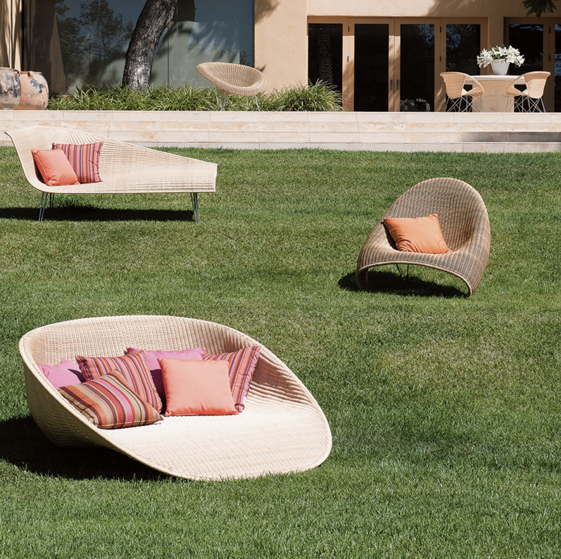 Coral outdoor pillows toned down with warm tones and tan. Janus et Cie - Fibonacci