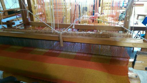 Weaving and loom at Helping Hands. This is a rug in the making.