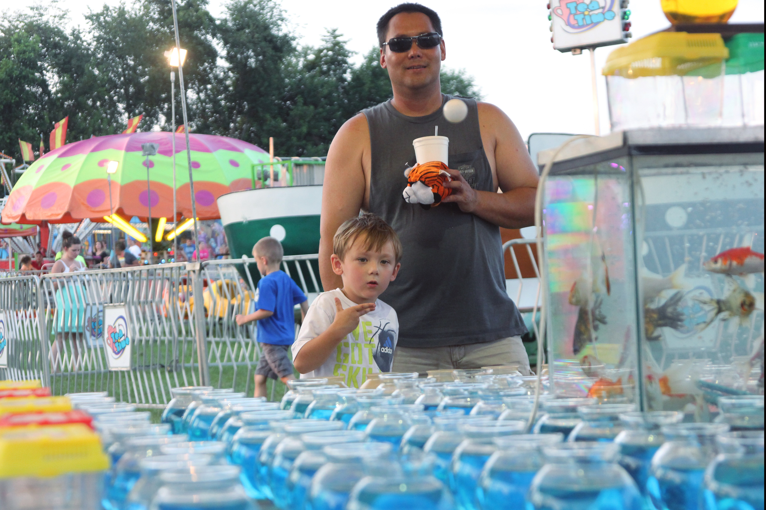  Ryan Watters, 4, throws his 12th ping-pong ball at the Pulaski Fair's goldfish toss.&nbsp;He missed.&nbsp; 