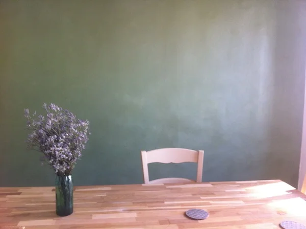 The dining room of My Paris Apartment, with its famous green wall