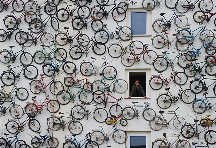 jonwithabullet:

Altlandsberg, Germany: Hundreds of bicycles hang on the facade of a rental shop