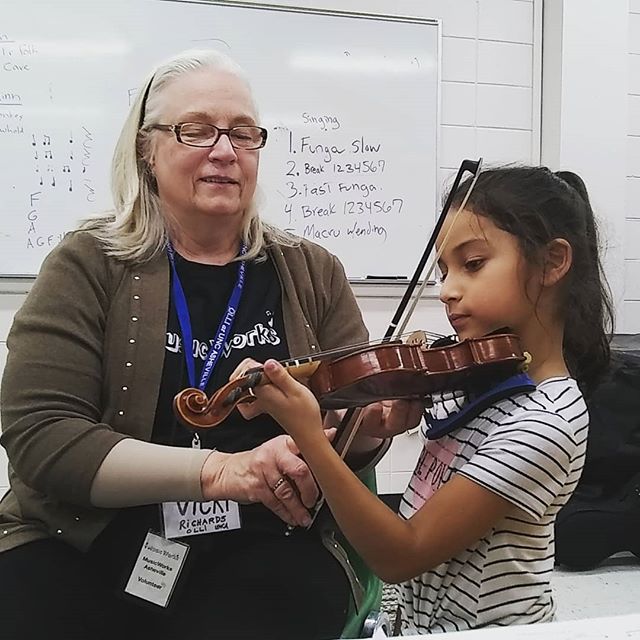 One of our fantastic volunteers is helping our girl Abby work on her violin skills. We really appreciate the volunteers that work with our students regularly and give their time to our program! #elsistemainspired #musicworks #violin #asheville #volun