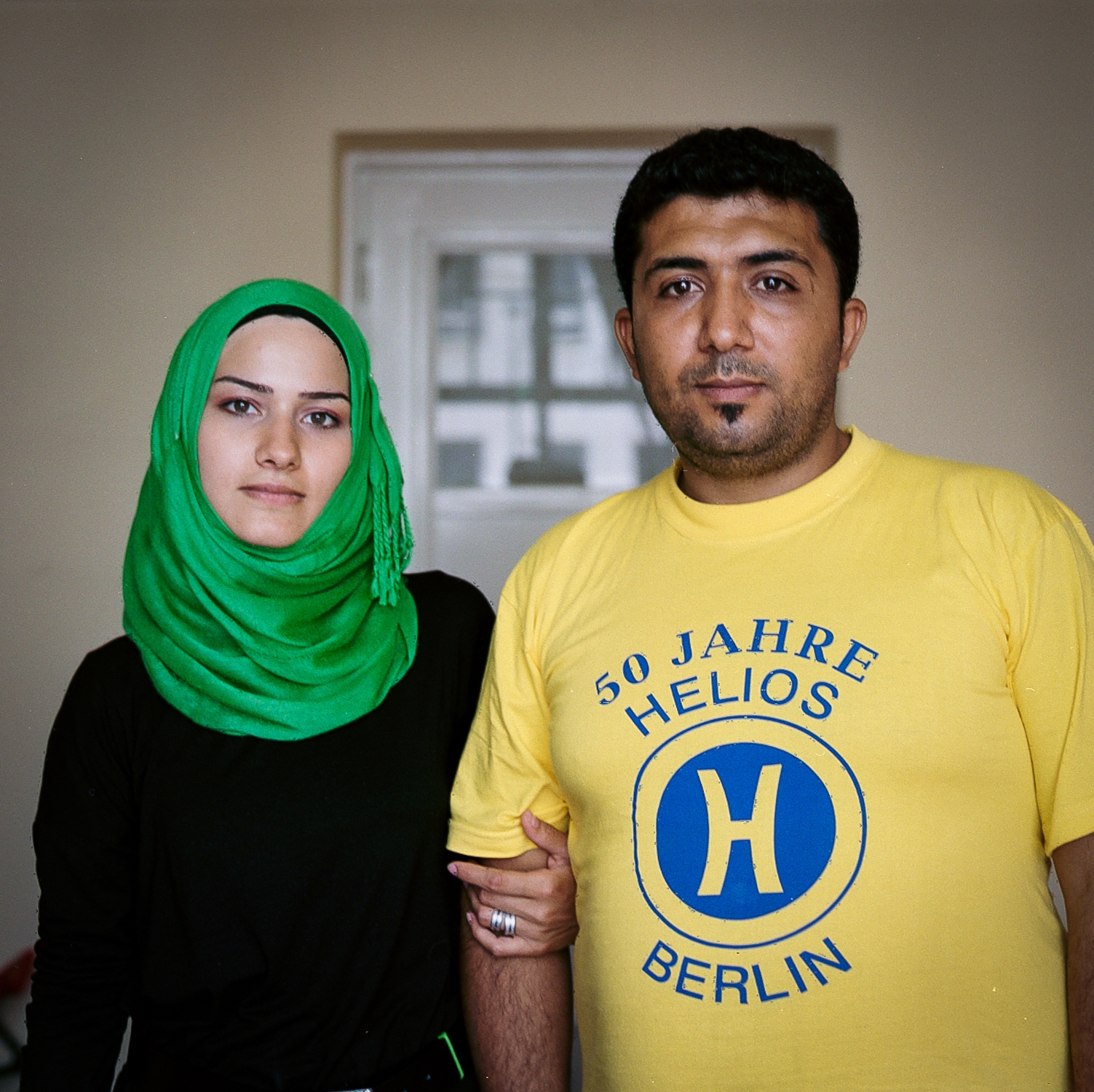 Nahed, 24, and Hassan, 32 In Aleppo, Hassan owned a toy store, and Nahed worked in a shop. Life was already hard without water and electricity due to the fighting and destruction of the city, but things got worse in July 2015, when during Ramadan, the different forces fought in Aleppo every night. Nahed and Hassan decided to take their two small children and leave Aleppo. Their journey to Germany took them 22 days, and many nights they slept on the streets. In the Hungarian camps their children, 4 and 7, were separated from them for two days and placed in separate cells. The Hungarian guards threatened Nahed to take her hijab away if she did not let herself be fingerprinted. For Hassan the hardest thing about leaving home was to say farewell to his parents. Syria is their home, but Hassan says that now the most important thing is the future of their children. August 19, 2015.