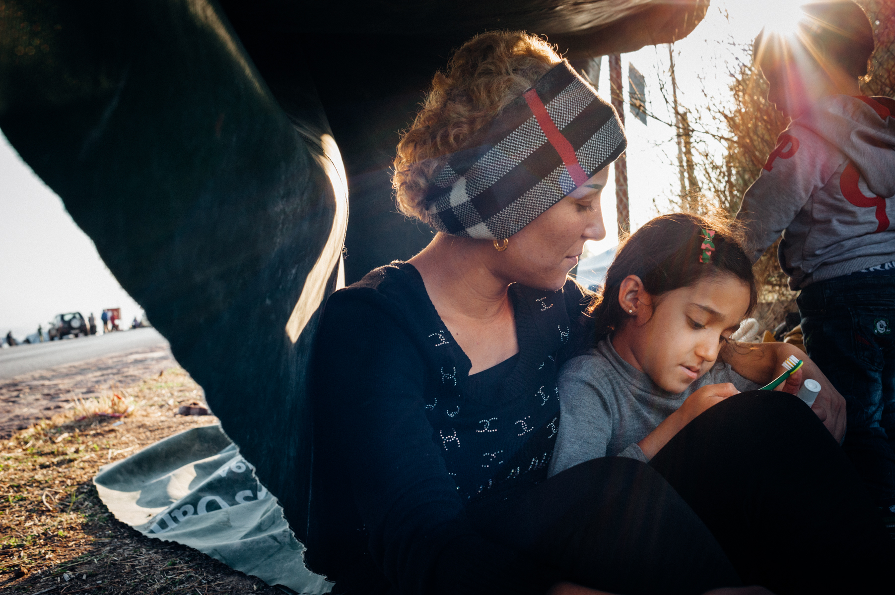 Jwana, 32, a young Syrian mother and widow, sitting with her twins Mariam, 6, and Youssef, 6, under a makeshift tent, awaiting further transport in Lesvos, Greece. Oct 3, 2015.