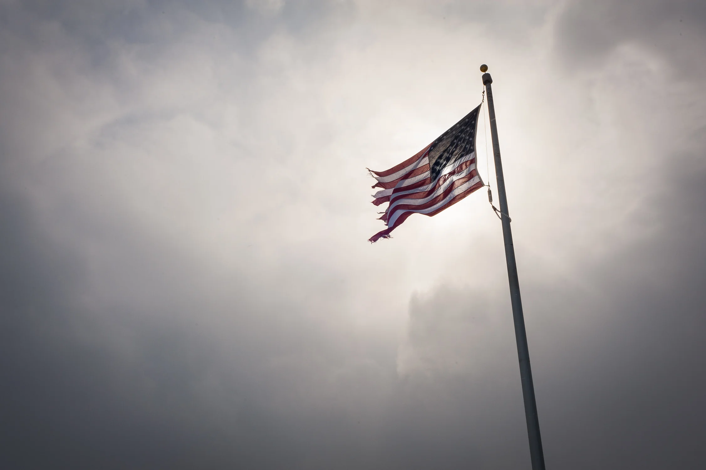 The American Flag 20 miles north of Albion Correctional Facility. Most long term inmates don't have a release date and many know depending on the sentence, if they will ever leave prison. Families oftentimes do not know whether they will ever live together agan. An estimated 2.7 million American children have a parent in prison. Every Friday and Saturday night hundreds of New Yorkers, mostly women, many with children, get on private buses and mini vans to drive all night in order to spend a few hours the next day with their husbands, brothers, mothers and fathers, who have been placed in prisons at the Northern end of New York state. February 15, 2014.