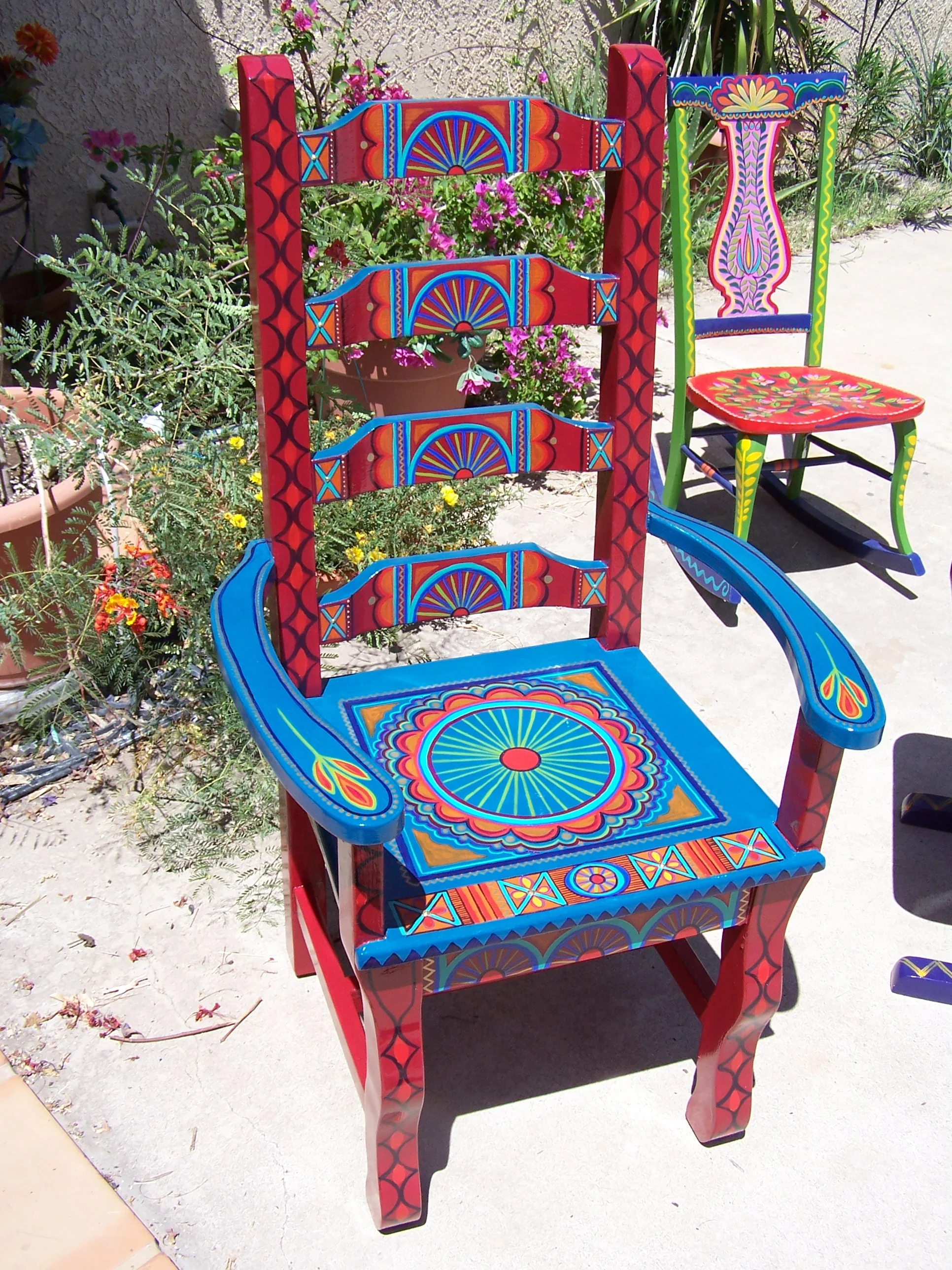  One old rocking-chair in front, an old straight chair behind it. 