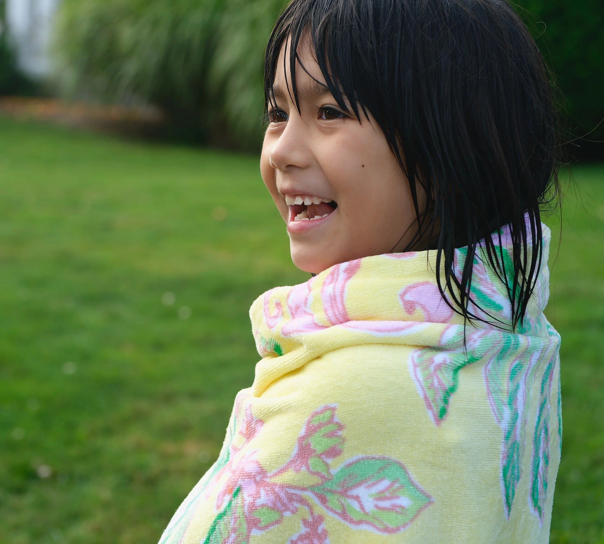 Child wrapped in a towel after playing in the ocean.