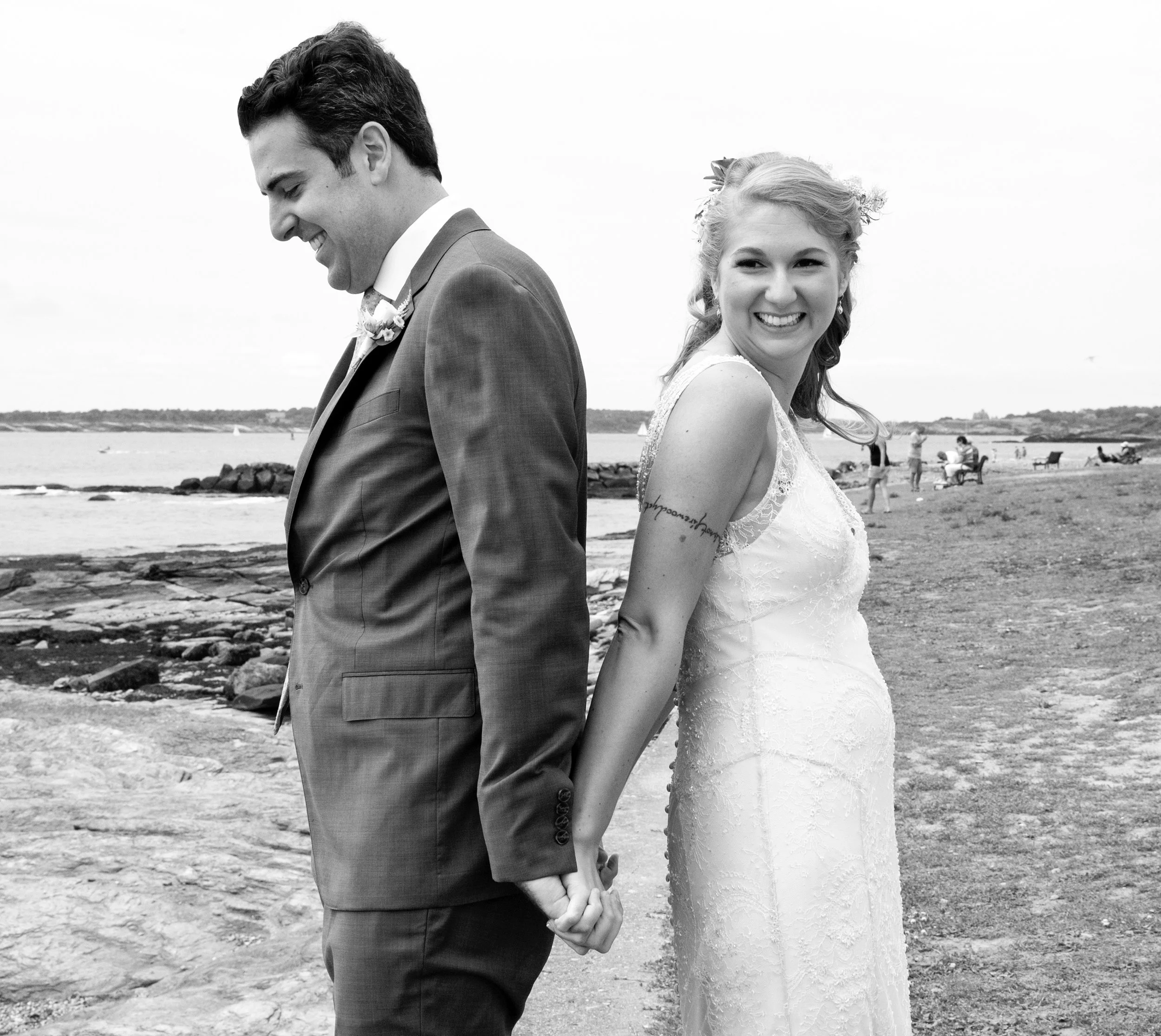 Bride and groom back to back during their first look at Brenton Point State Park in Newport, RI