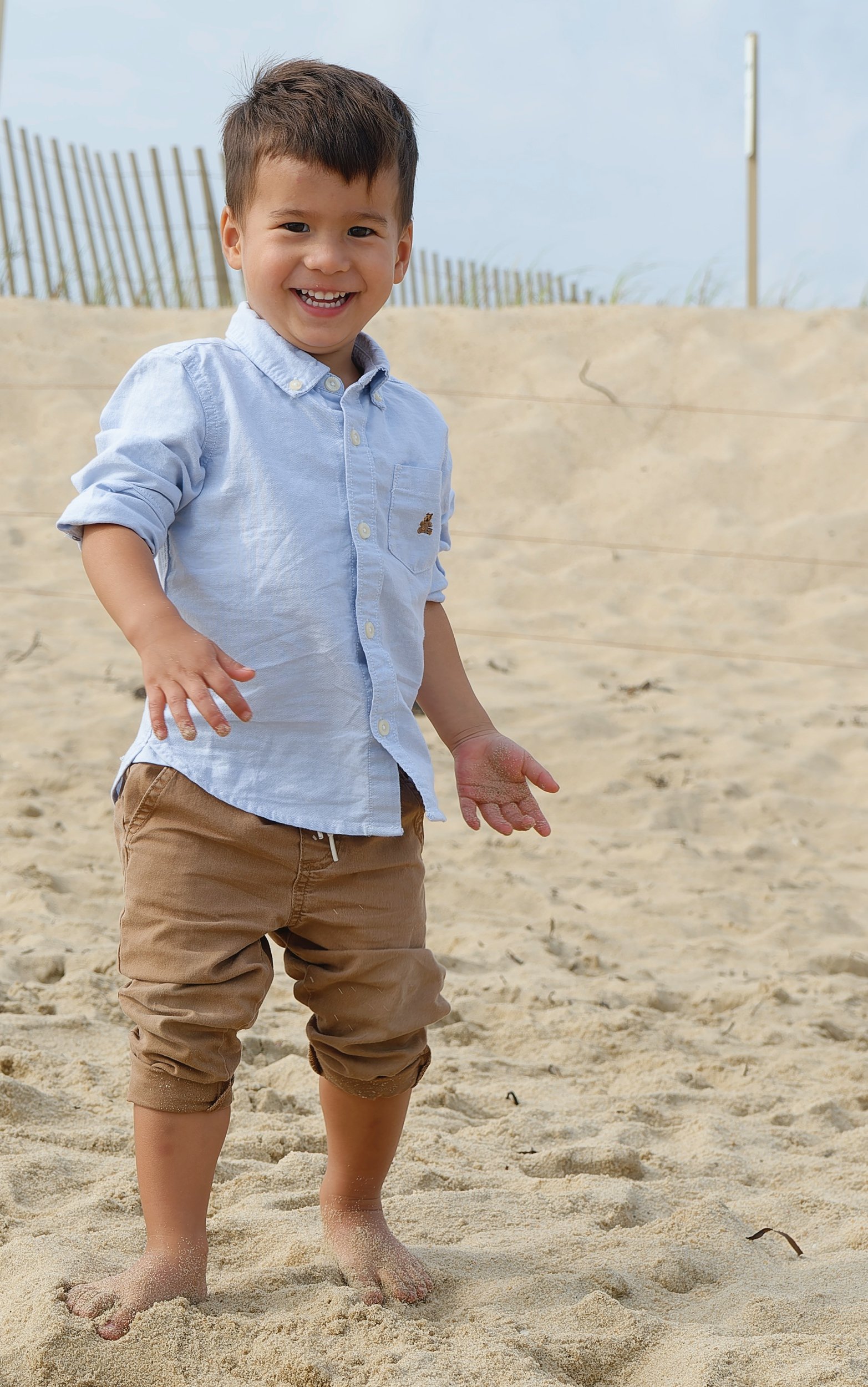 Young boy walking across the sand on Martha's Vineyard beach.