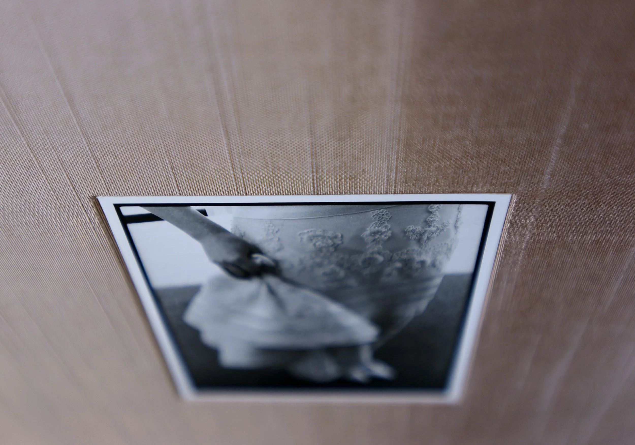Close up of photograph hand mounted onto elegant pale taupe silk book cloth cover