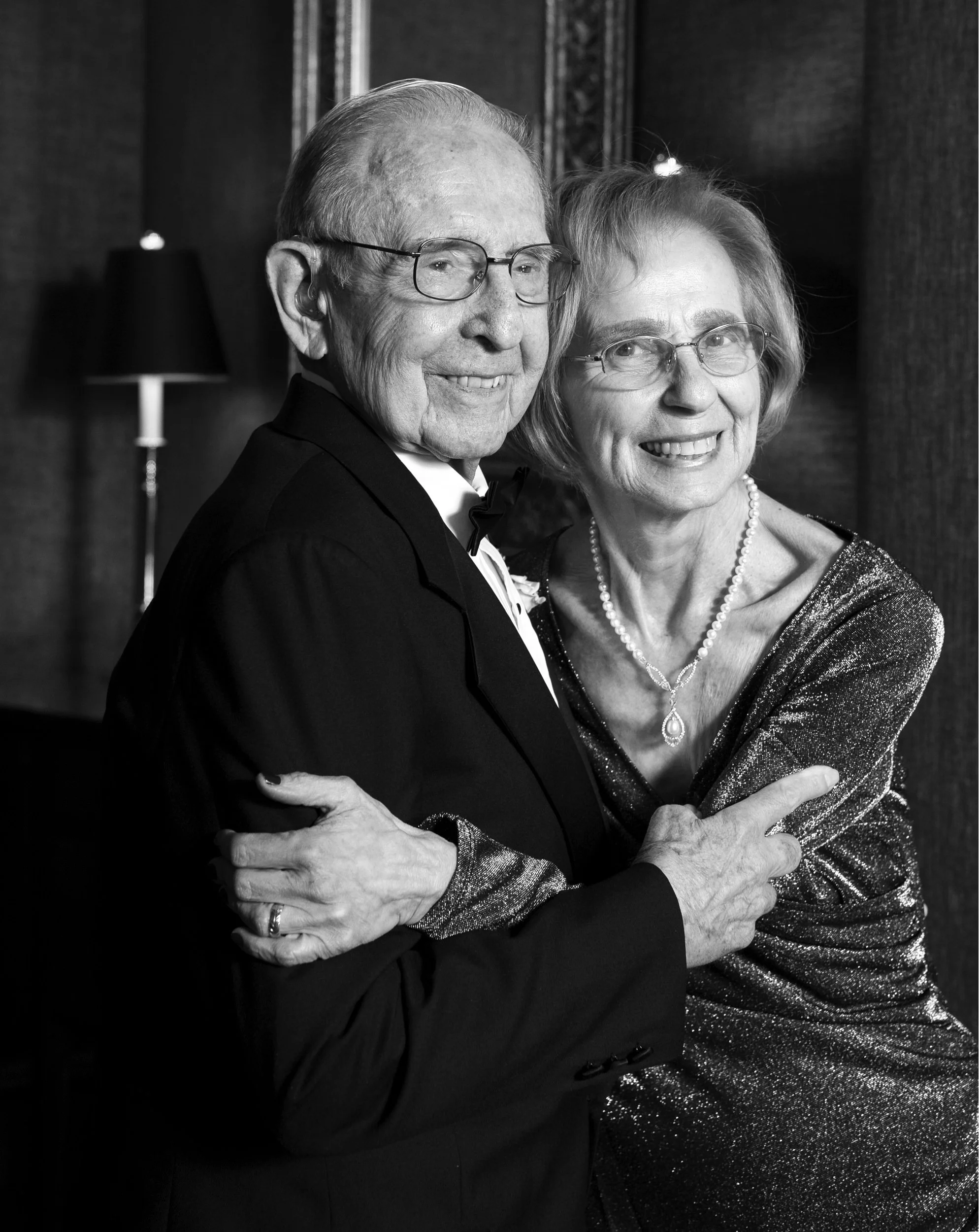 Gladys and Morris embrace during their anniversary celebration at Boston Harbor Hotel.
