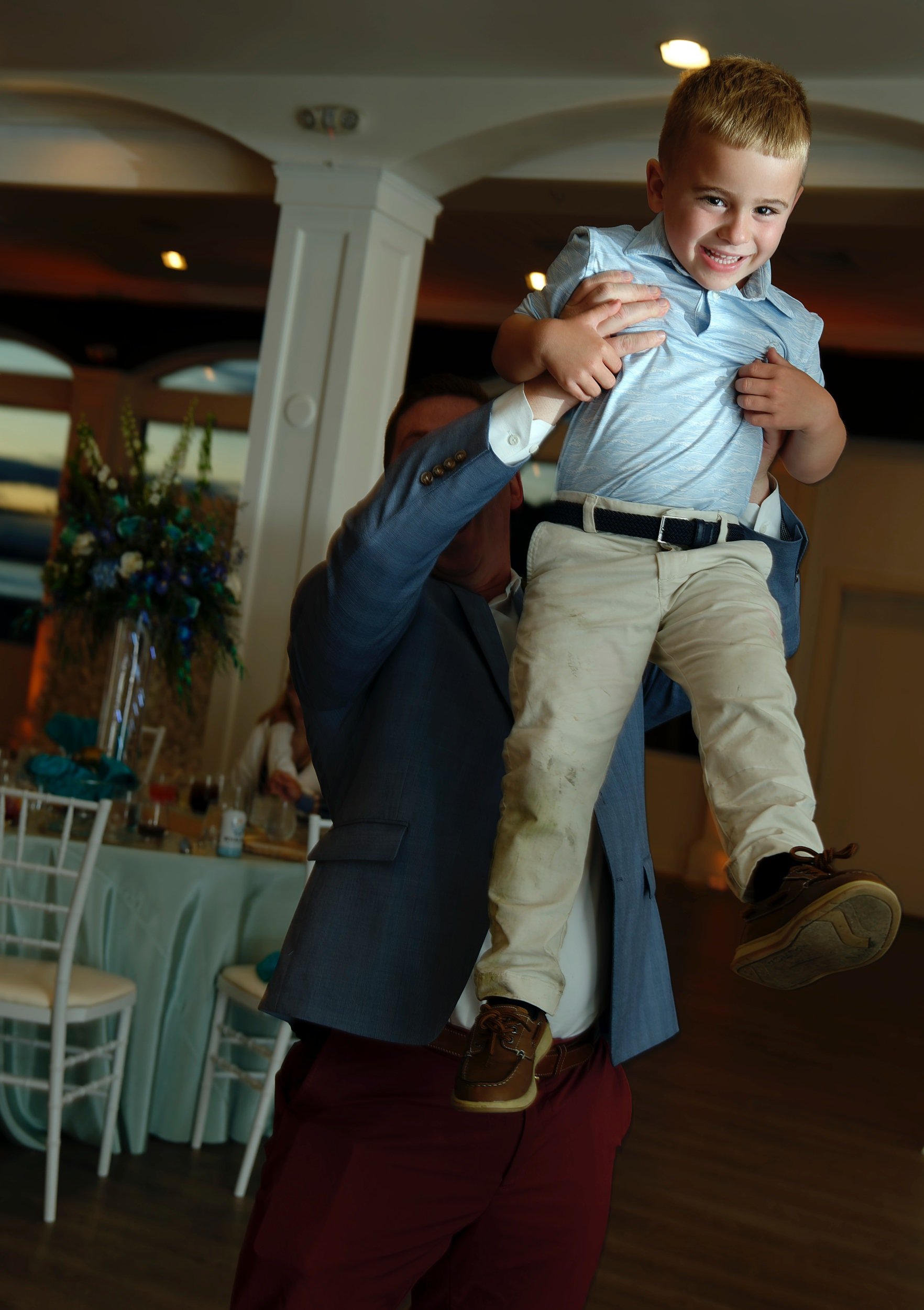 Father dancing with a young family member during the celebration