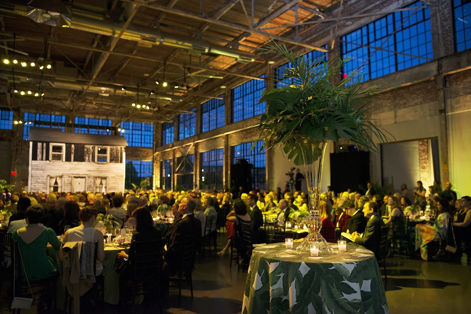 Dramatic event lighting inside WaterFire Arts Center during the evening gala celebration
