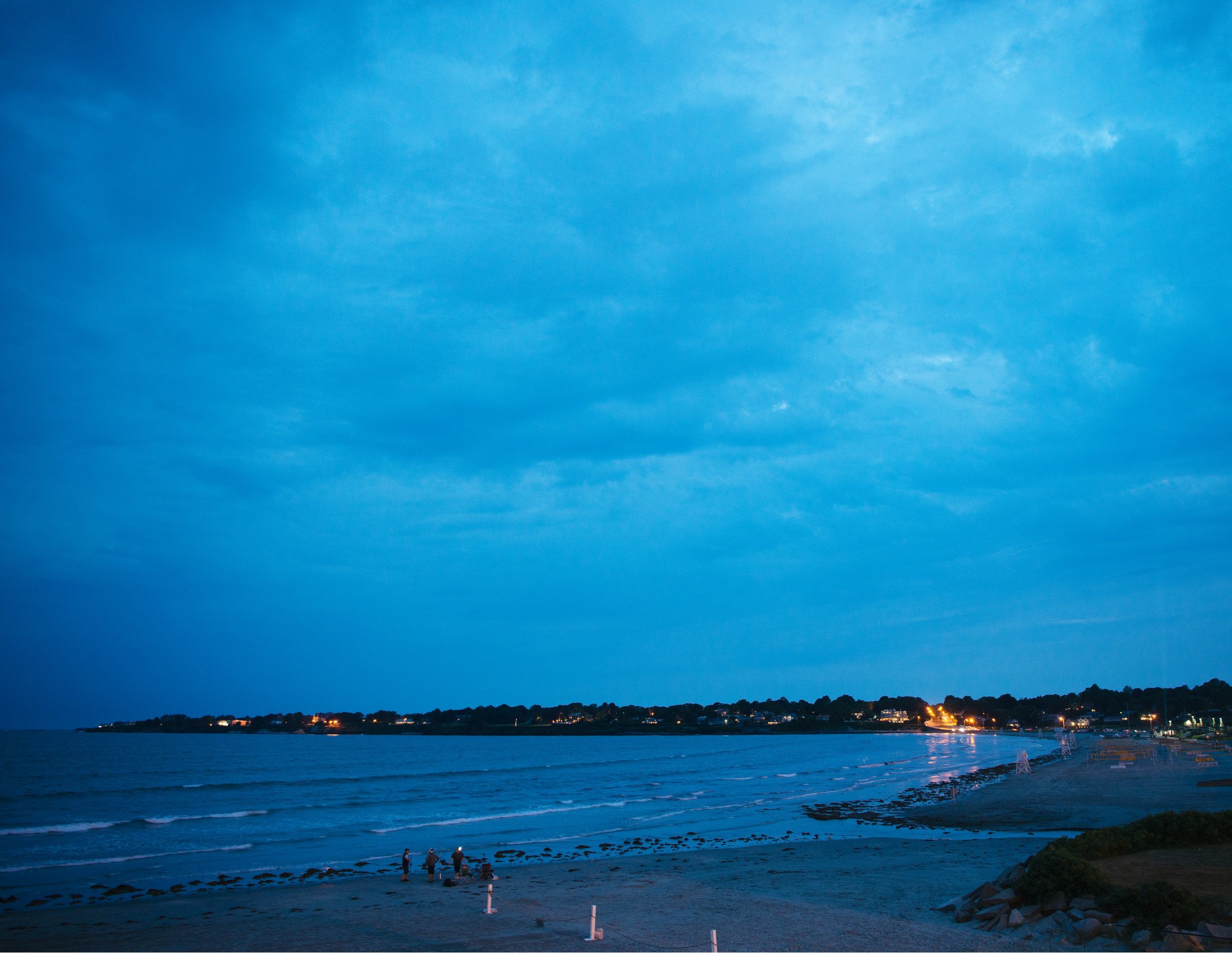 Blue-hour view from Newport Beach House of the beach and water