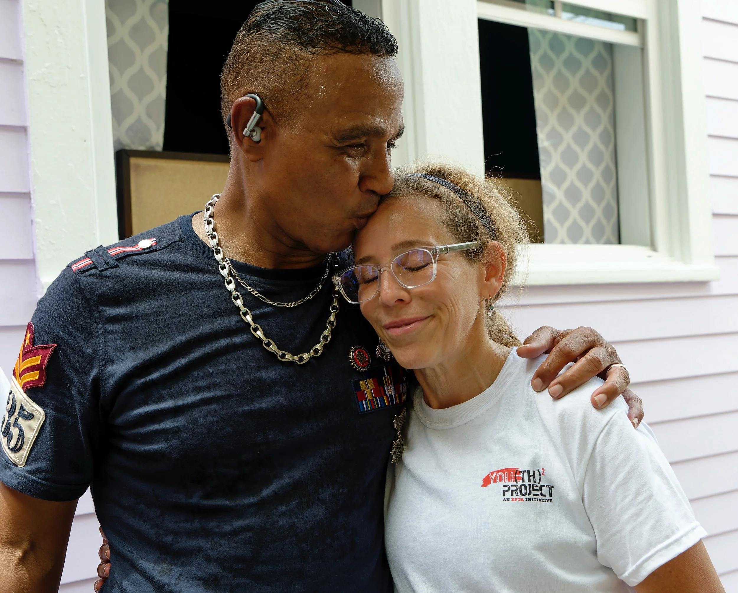 Recipient embracing Susie Perelman of Event Pros Take Action after completing a volunteer project for Saint Bernard Project rebuilding efforts in New Orleans, LA.