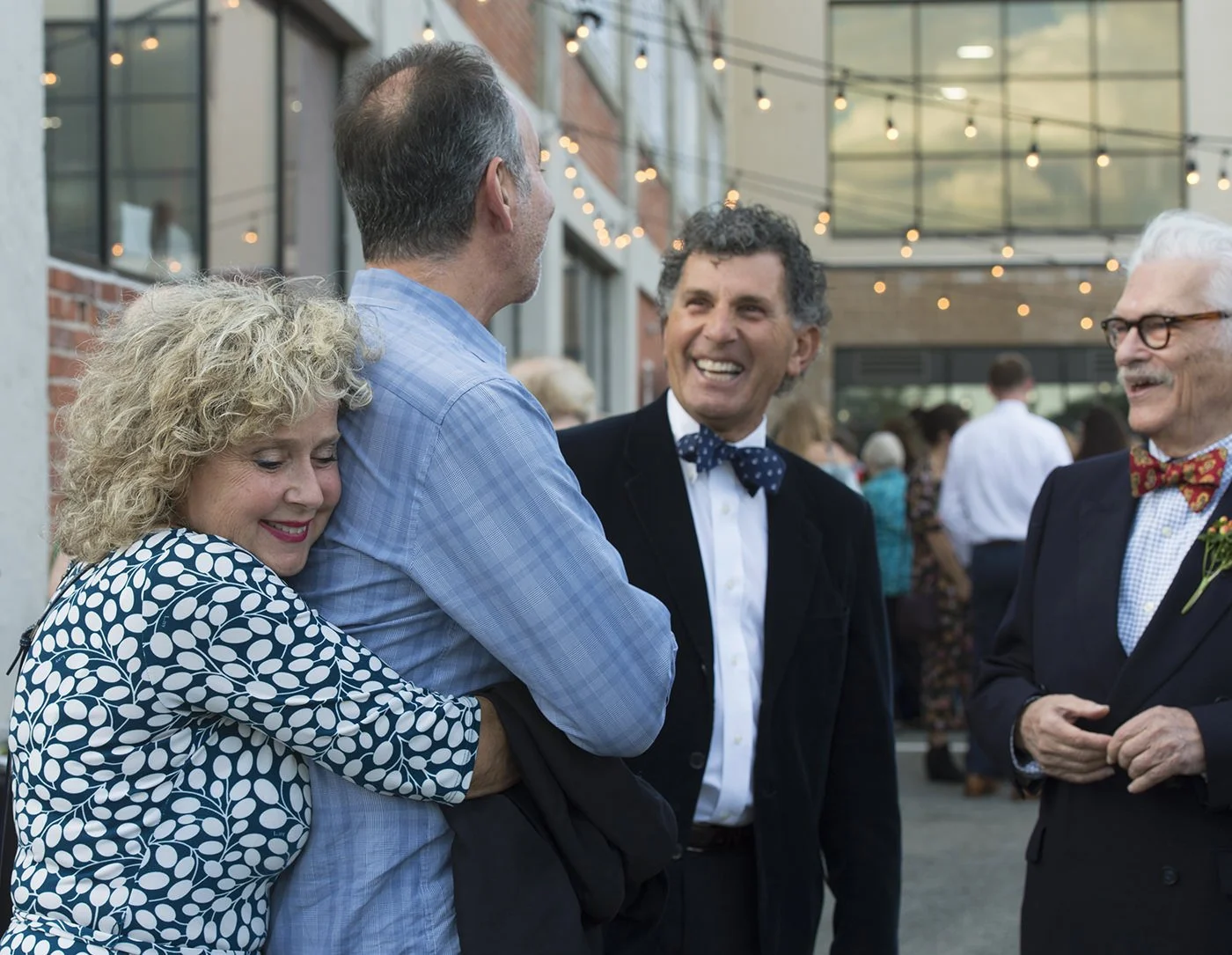 Candid moment between Phyllis & Morris Nathanson, Robert Billington, and guest at Revel Factory event, Pawtucket, RI