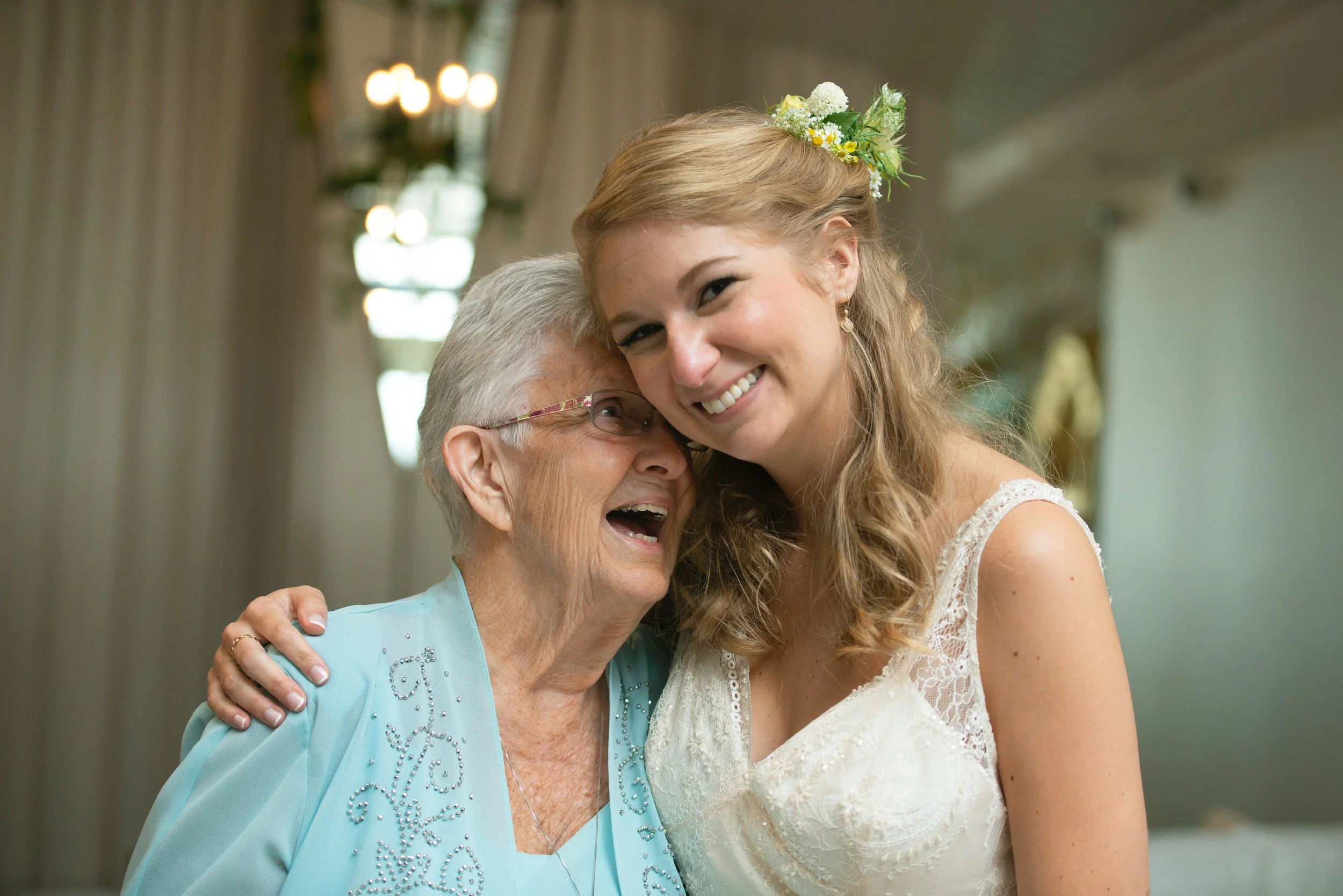 Joyous moment between bride and grandmother portrait inside Newport Beach House