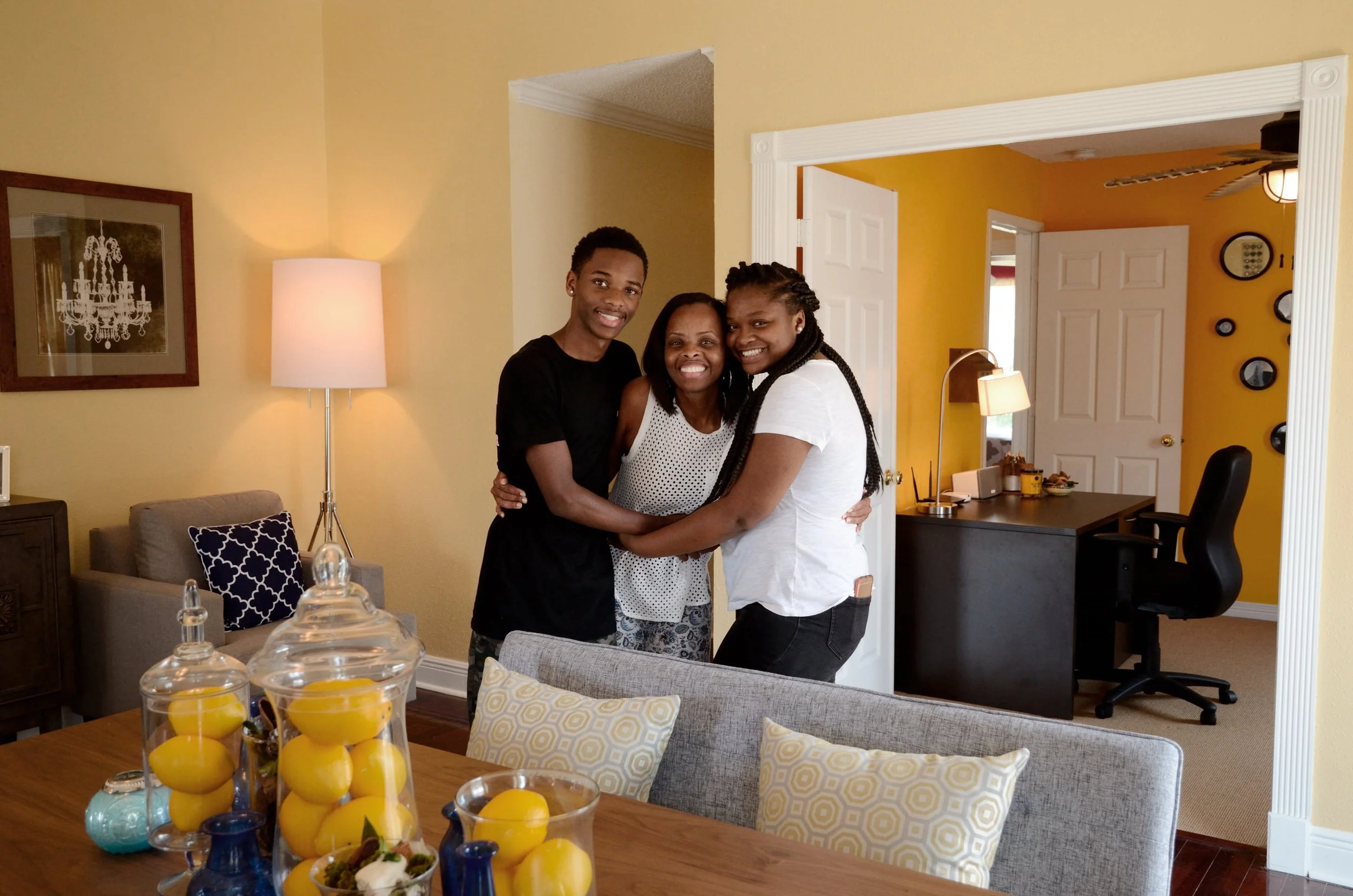 Family portrait inside a rebuilt New Orleans home after Saint Bernard Project rebuilding effort in New Orleans.