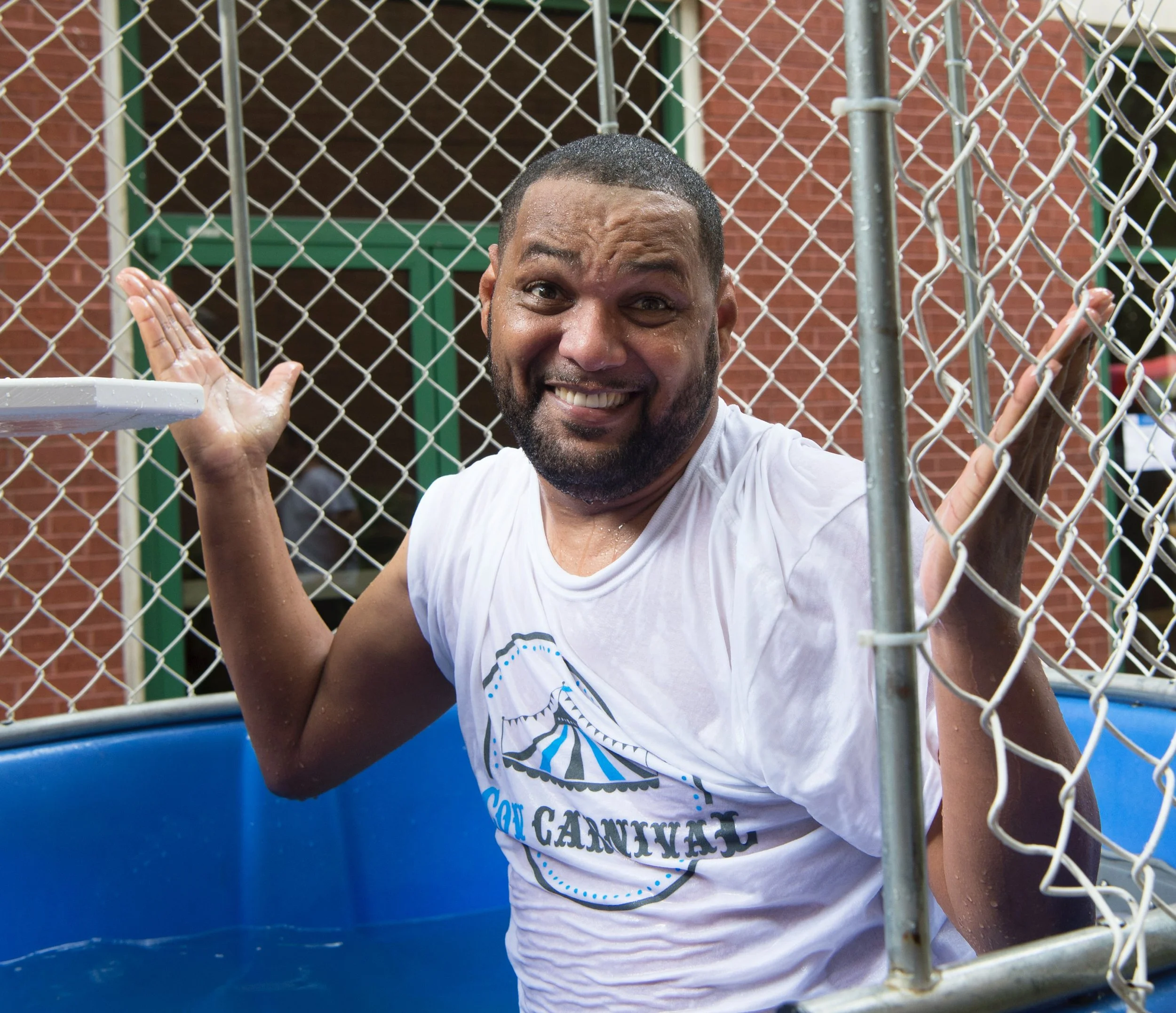 Volunteer posing at carnival dunking booth during CovCarnival.