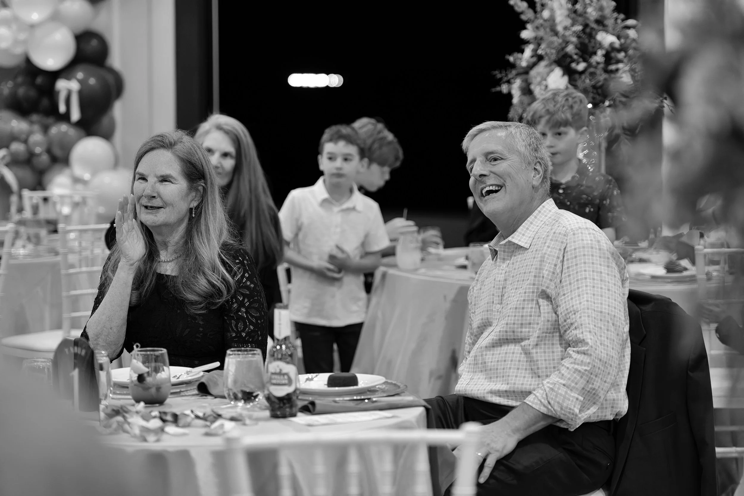 Linda and Joe listening to toast during their anniversary celebration