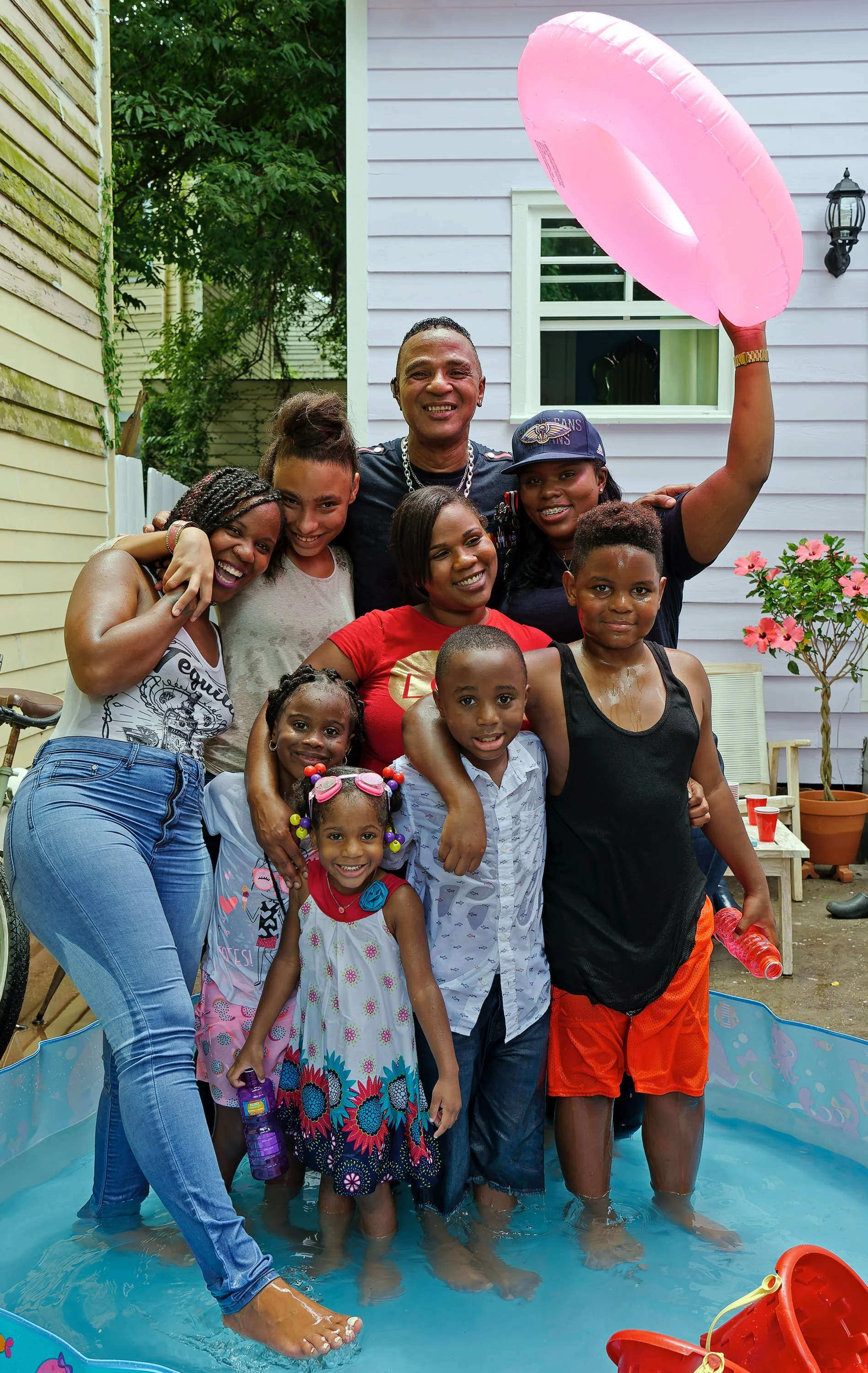 Fun family portrait in a children's pool after a St. Bernard Project ribbon cutting with EPTA.