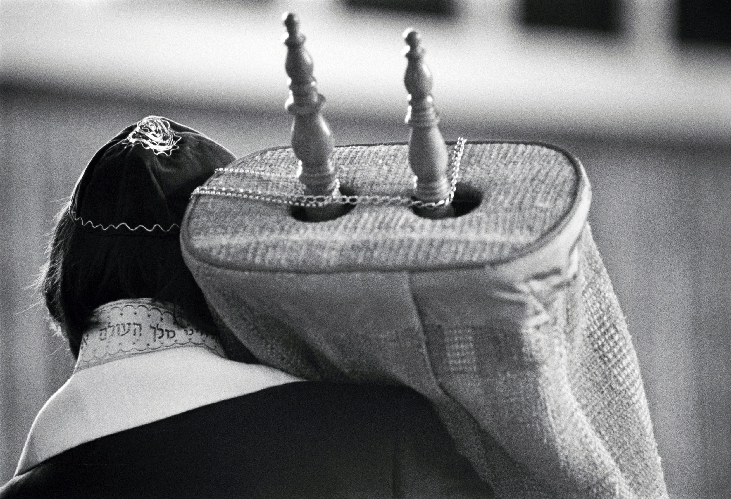 Bar Mitzvah boy holds the Torah, photographed on black-and-white film.
