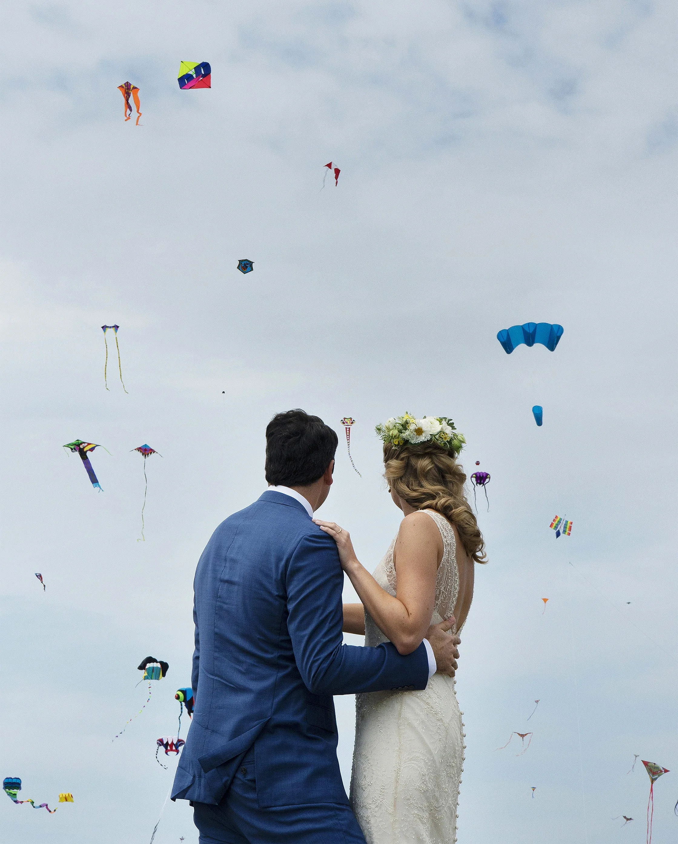 Bride and groom watch kites at Brenton Point in Newport, Rhode Island.