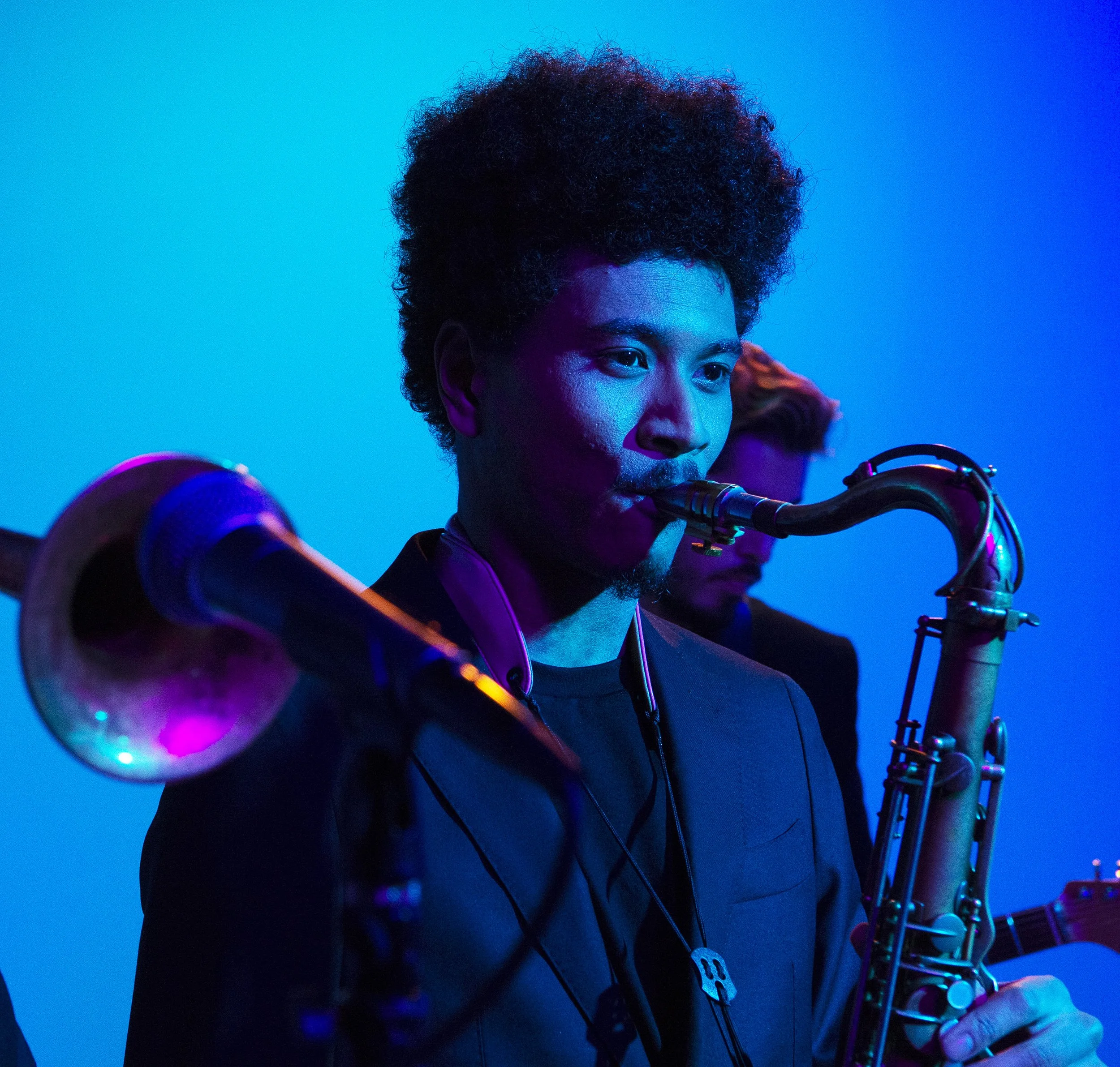 Moody cold tone color photograph of horn player during Soul of Boston production for Hank Agency Group.