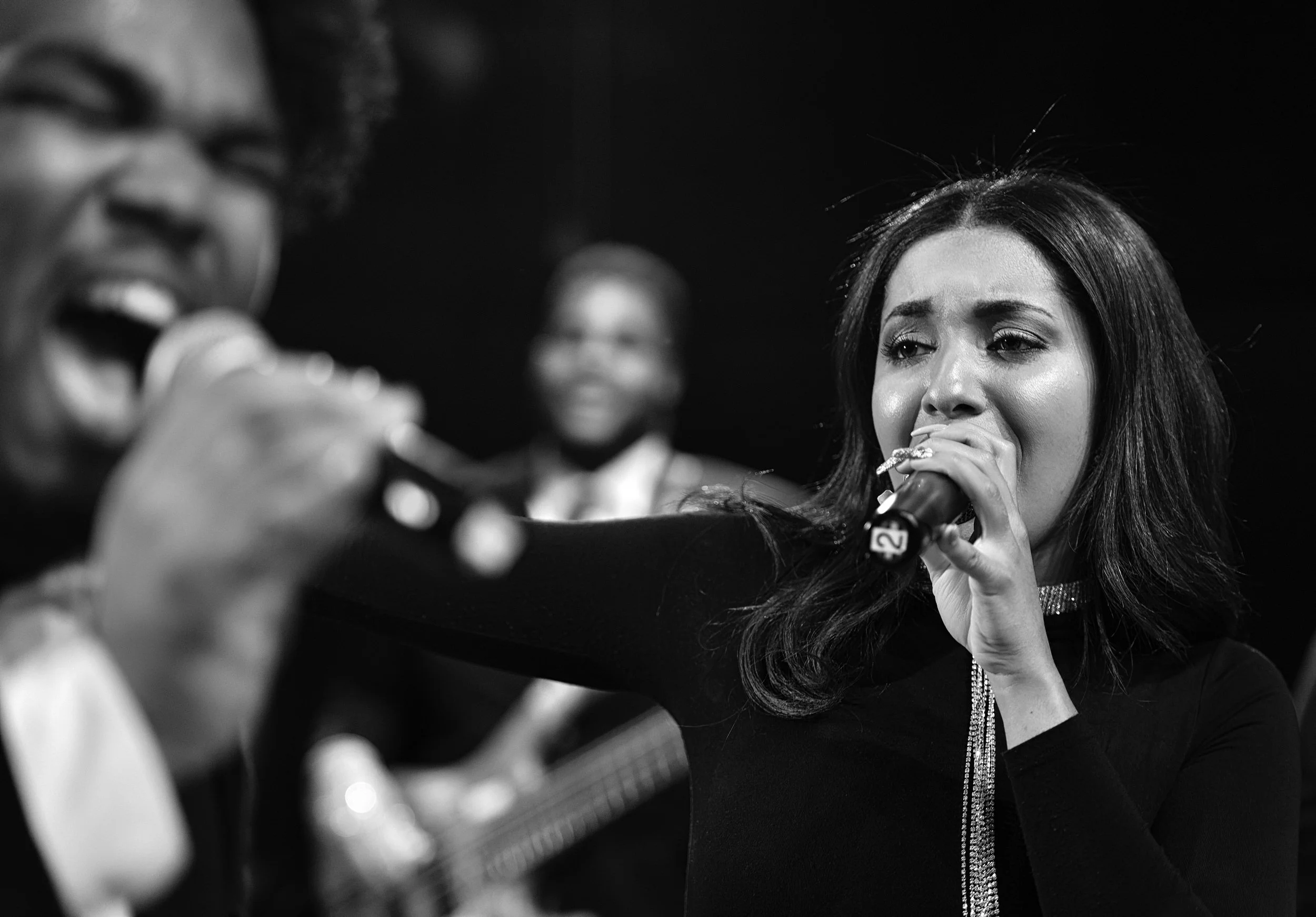 Black and white selective focus of lead singers during UMANI music video production at SIR Music Studio in New York City for Hank Agency Group.