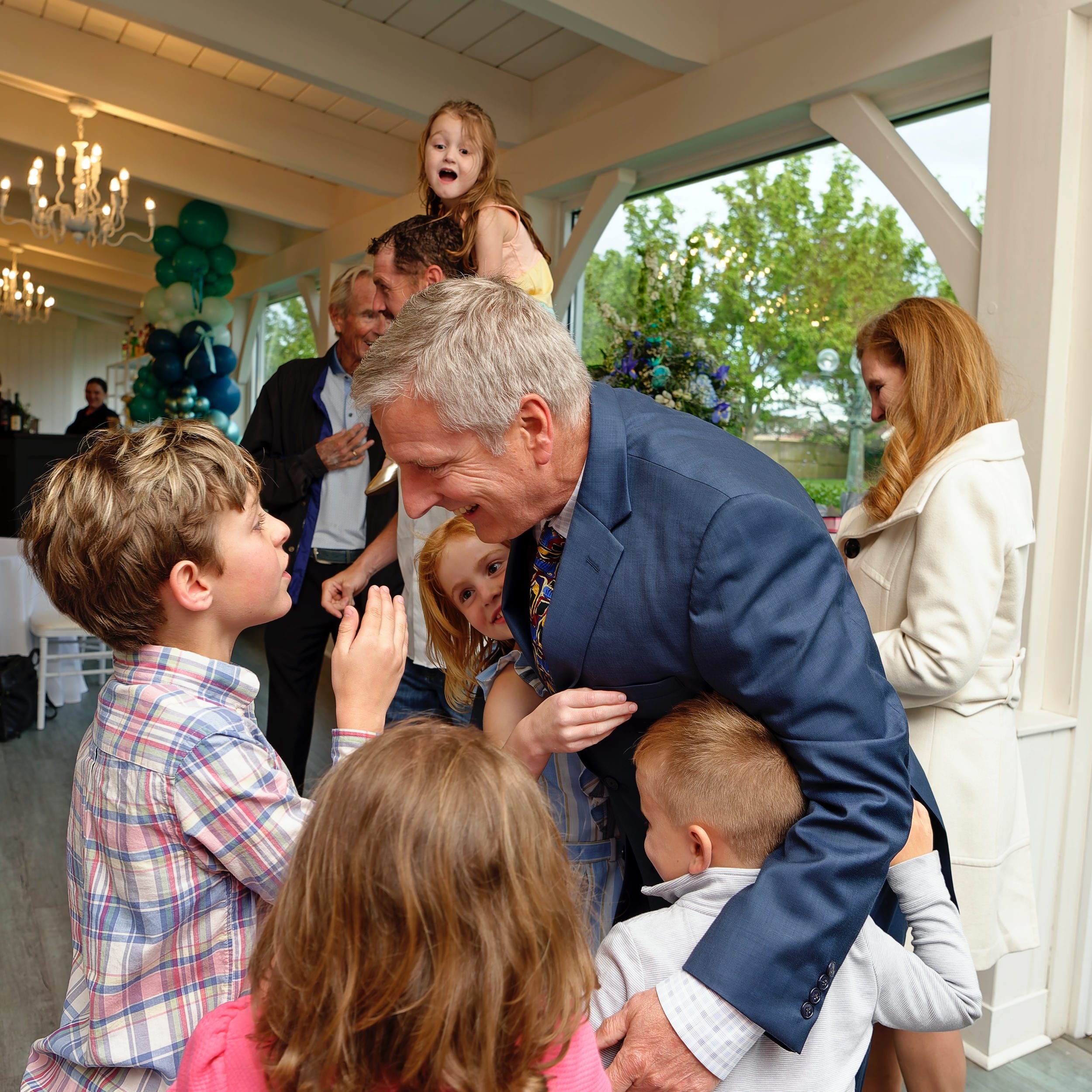 Family greeting one another during Linda and Joe's anniversary celebration