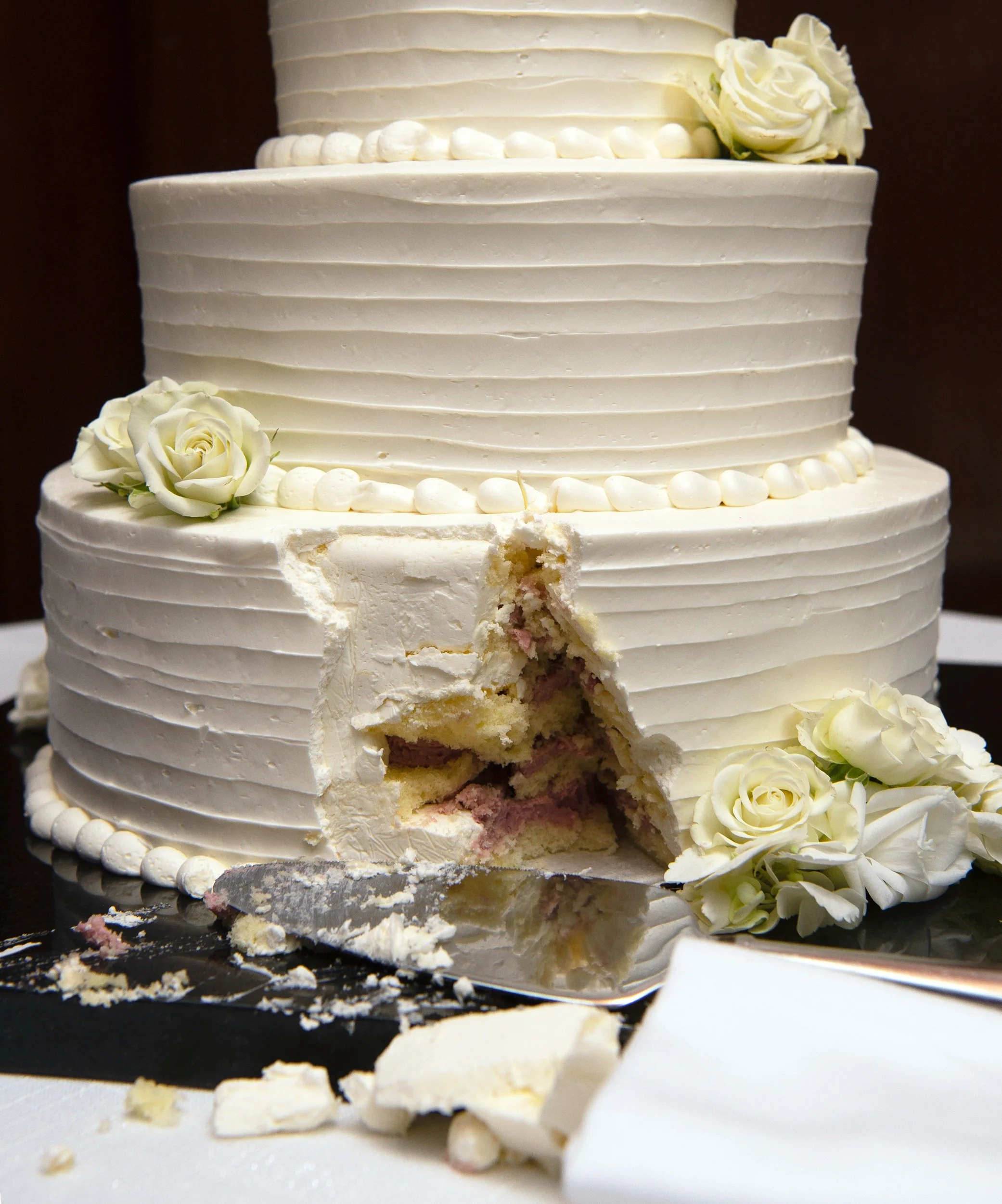 Anniversary cake with slice cut out of it before dessert was served.