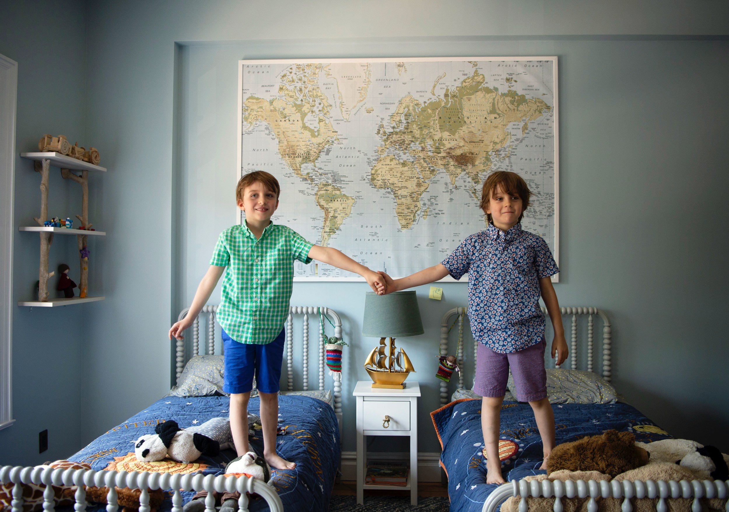 Brothers standing together in a bedroom before the celebration