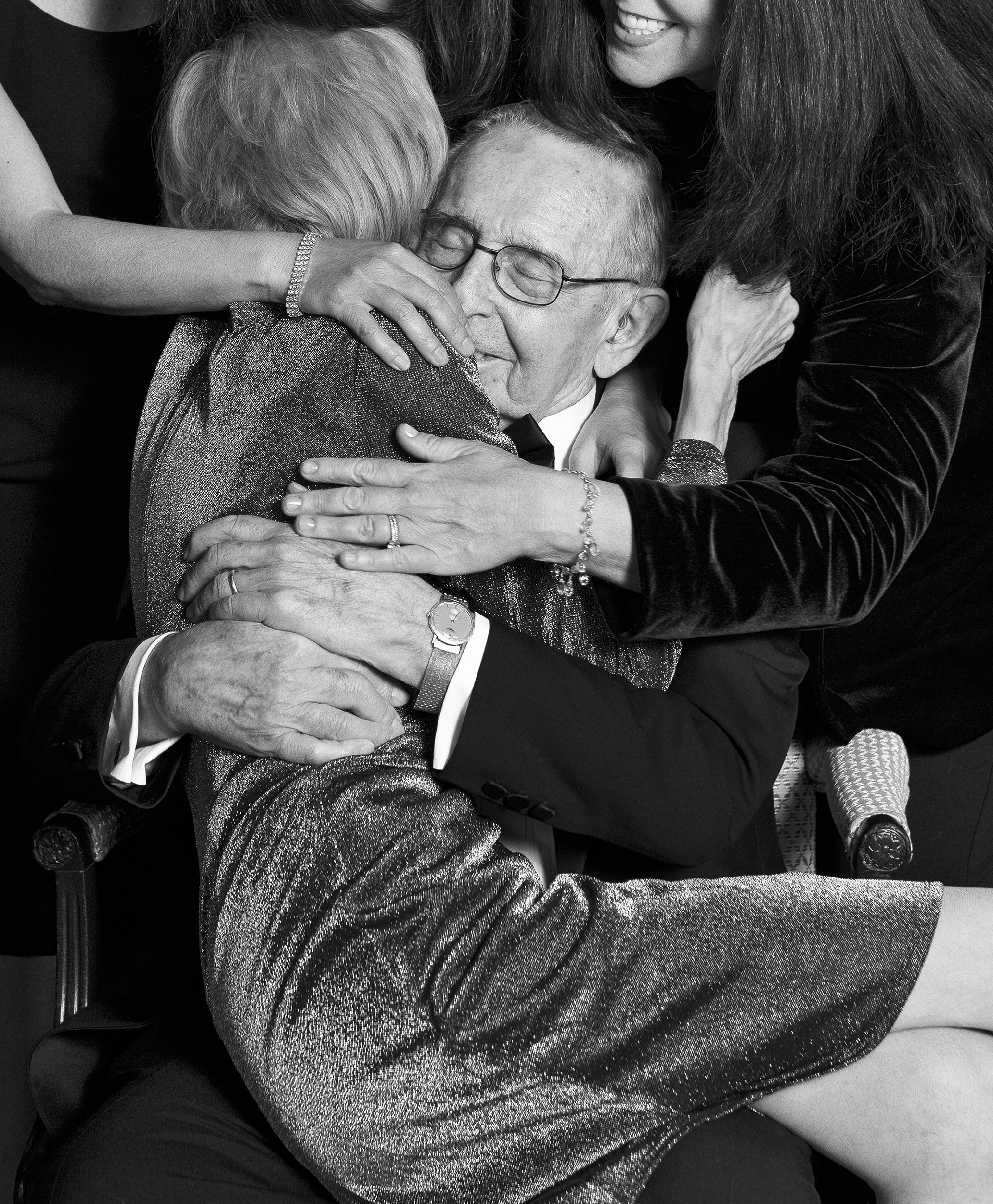 Black-and-white portrait of daughters embracing Gladys and Morris at their anniversary celebration at the Boston Harbor Hotel.