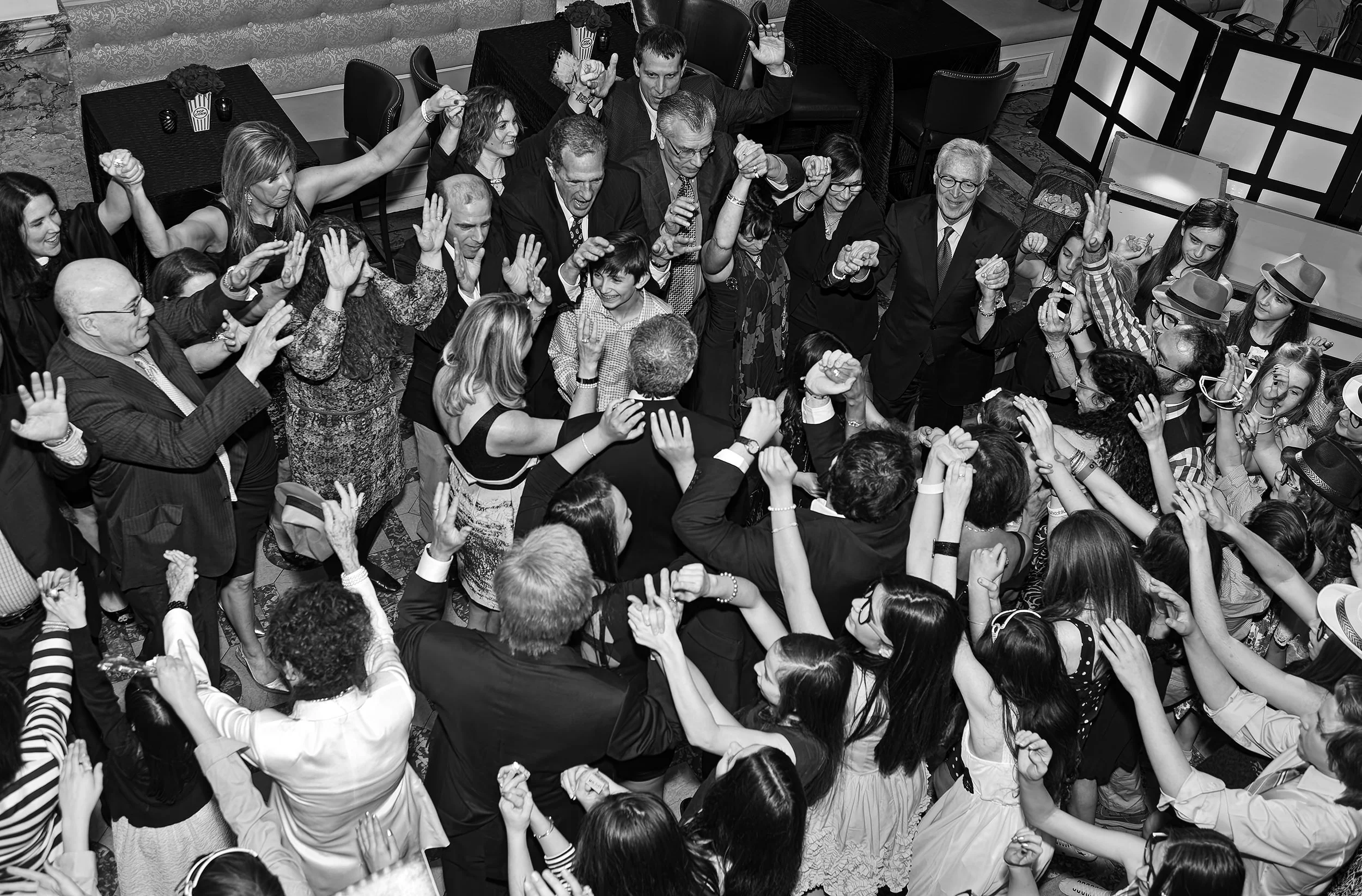 Black and white image of the hora, taken from above in black & white, showcasing the energy and togetherness of friends and family.